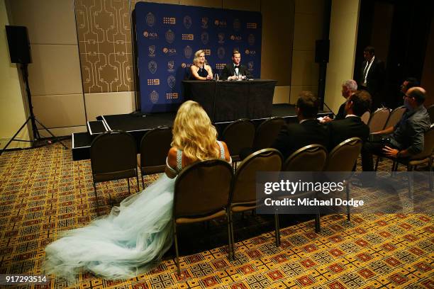 Danielle Willis watches her partner and Allan Border Medal winner Steve Smith speak with Ellyse Perry who won the Belinda Clark Award at the 2018...