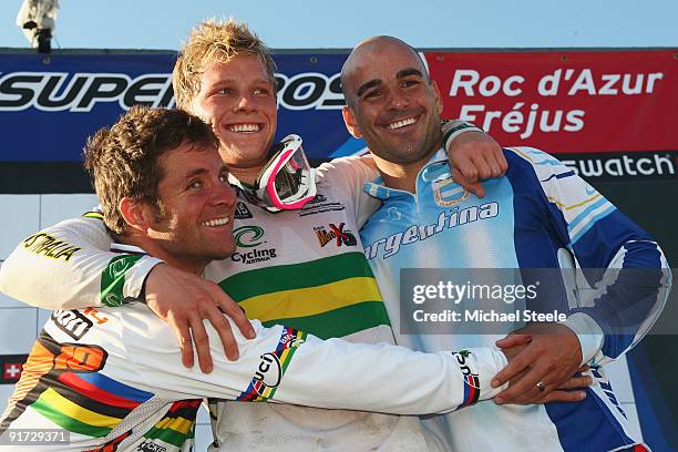 Sam Willoughby of Australia celebrates victory and overall World Cup number one status alongside Donny Robinson of USA and Cristian Becerine of...