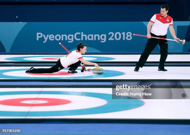 Jenny Perret of Switzerland throws a rock as Martin Rios waits to sweep in a 7-5 victory over the Olympic Athletes from Russia team to advance to the...