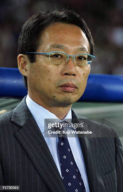 Japan team coach Takeshi Okada waits for the start of the Kirin Challenge Cup 2009 match between Japan and Scotland at Nissan Stadium on October 10,...