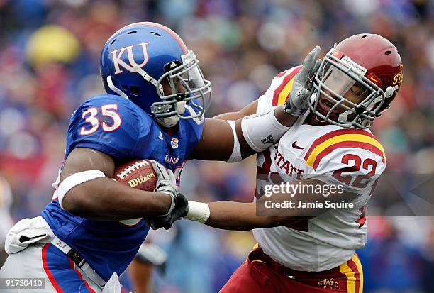 Running back Toben Opurum of the Kansas Jayhawks stiffarms Ter'ran Benton of the Iowa State Cyclones during the game on October 10, 2009 at Memorial...