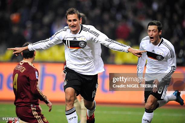 Germany's striker Miroslav Klose celebrates scoring the 0-1 under the eyes of Germany's midfielder Mesut Oezil during their Russia vs Germany...