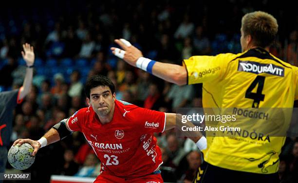 Nenad Vuckovic of Melsungen is challenged by Oliver Roggisch of Rhein-Neckar Loewen during the Toyota Handball Bundesliga match between MT Melsungen...