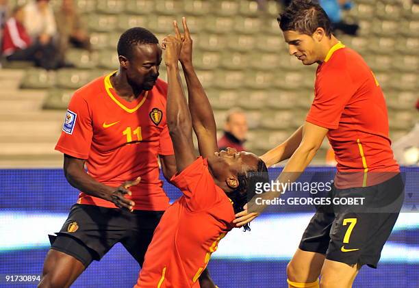 Belgian Emile Mpenza , Roland Lamah and Kevin Mirallas celebrate after scoring during their World Cup 2010 group 5 qualifying football match against...