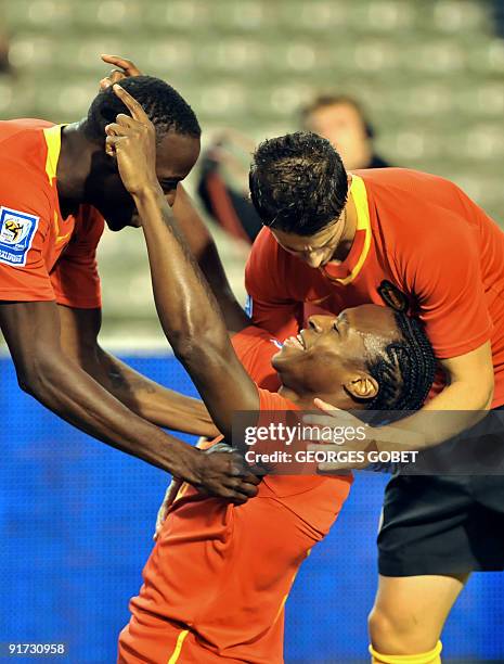 Belgian's Emile Mpenza Roland Lamah and Kevin Mirallas celebrate scoring during their World Cup 2010 group 5 qualifying football match in Brussels...