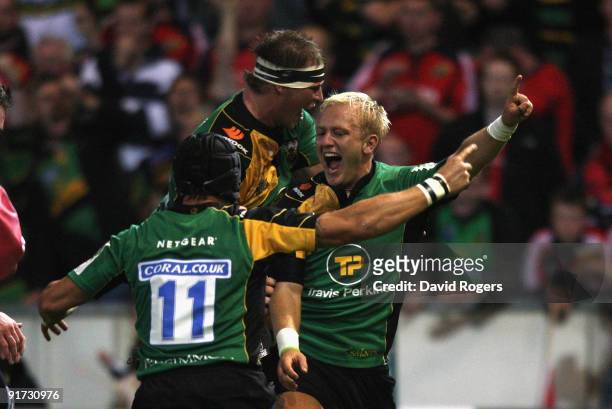 Shane Geraghty of Northampton celebrates after scoring his teams second try with team mates Bruce Reihana and Dylan Hartley during the Heineken Cup...