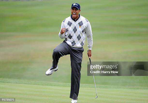 Tiger Woods of the USA Team celebrates his putt for a birdie to win the 17th hole during the Day Three Morning Foursome Matches of The Presidents Cup...