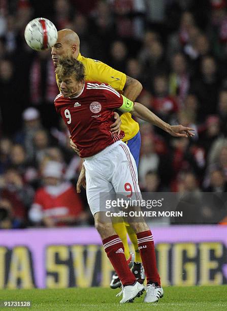 Denmark's Jon Tomasson struggles for the ball with Sweden's Daniel Majstorovic during their World Cup 2010 qualifying match on October 10, 2009 at...