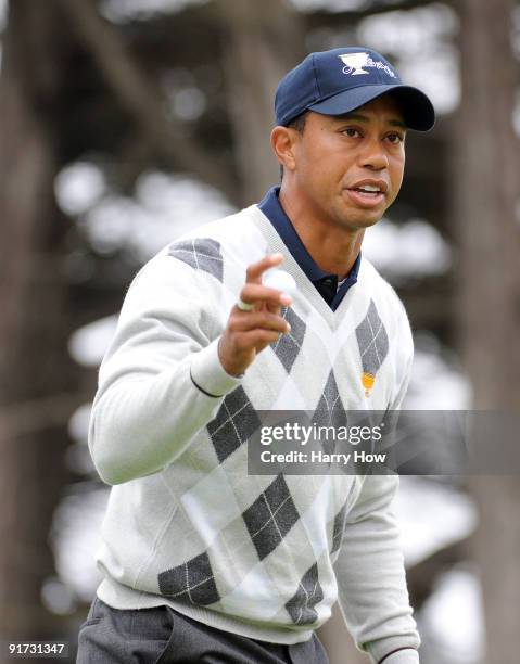 Tiger Woods of the USA Team reacts to his birdie to win the the 13th hole during the Day Three Morning Foursome Matches of The Presidents Cup at...