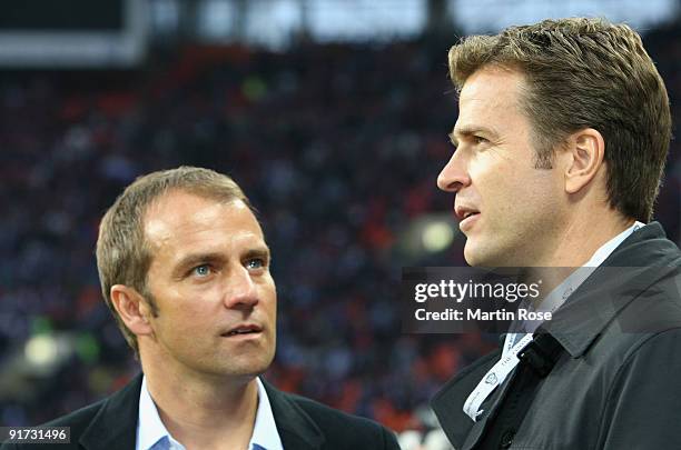 Team manager Oliver Bierhoff of Germany talks to assistant coach Hansi Flick prior to the FIFA 2010 World Cup Group 4 Qualifier match between Russia...