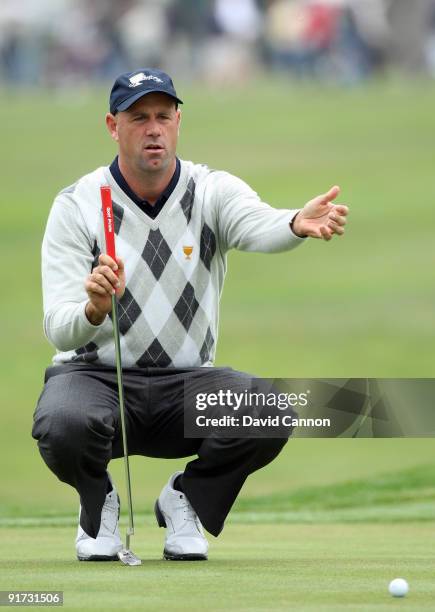 Stewart Cink of the USA Team lines up a putt at the 16th hole from the edge of the lake during the Day Three Morning Foursome Matches in The...