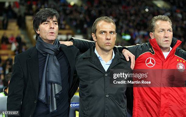 Head coach Joachim Loew of Germany, assistent coach Hansi Flick of Germany and goalkeeper coach Andreas Koepke line up prior to the the FIFA 2010...