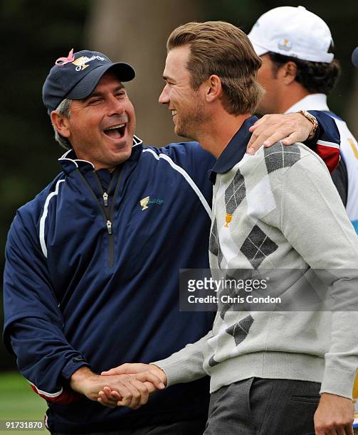Team Captain Fred Couples congratulates Sean O'Hair after Mickelson and O'Hair won their match on during the third round morning foursome matches for...