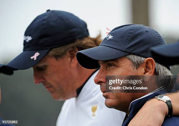Team Captain Fred Couples watches the action with Phil Mickelson after on during the third round morning foursome matches for The Presidents Cup at...