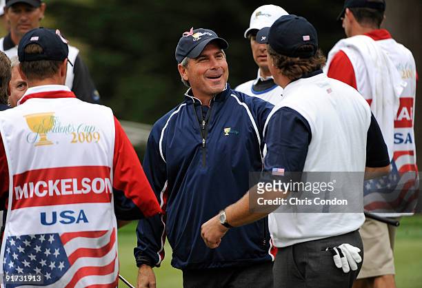 Team Captain Fred Couples congratulates Phil Mickelson after Mickelson and O'Hair won their match on during the third round morning foursome matches...