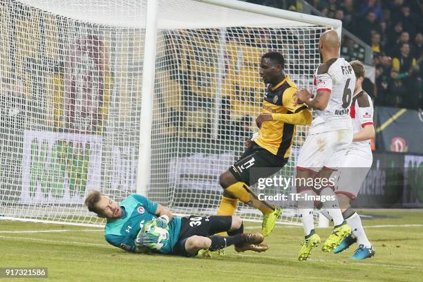 Goalkeeper Robin Himmelmann of St. Pauli, Peniel Mlapa of Dresden and Christopher Avevor of St. Pauli battle for the ball during the Second...