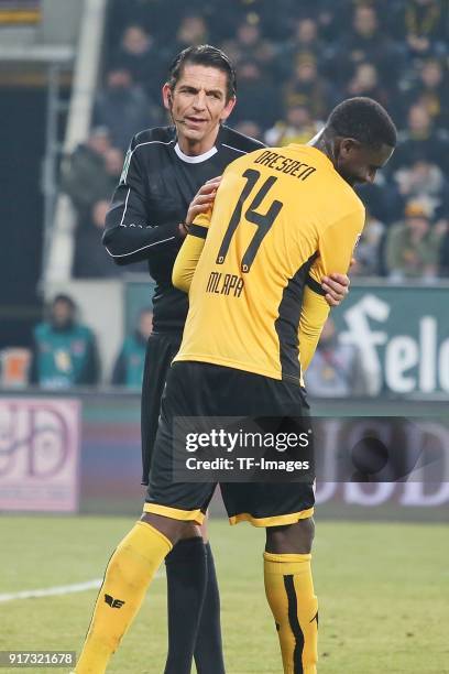 Referee Deniz Aytekin speaks with Peniel Mlapa of Dresden during the Second Bundesliga match between SG Dynamo Dresden and FC St. Pauli at...
