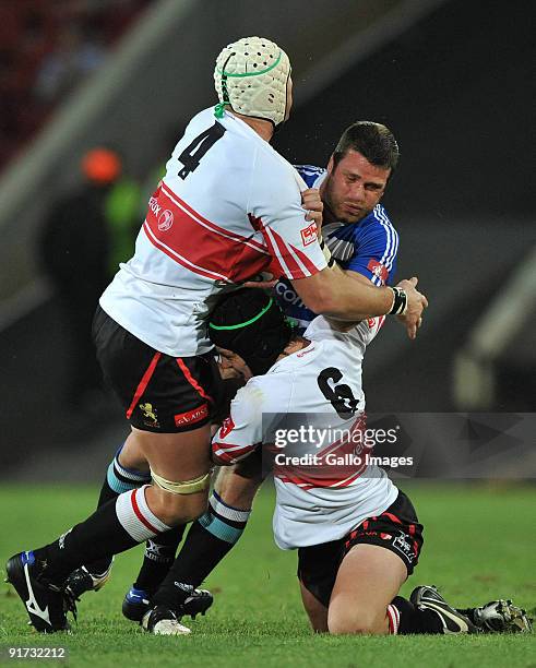 Luke Watson of Western Province tackled by Nico Luus and Cobus Grobbelaar of the Lions during the Absa Currie Cup match between Xerox Lions and...