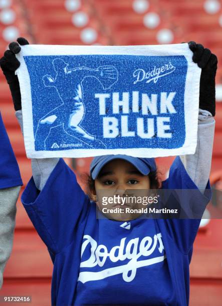 Young fan holds a sign to support the Los Angeles Dodgers before the start of Game Three of the NLDS during the 2009 MLB Playoffs between the St....