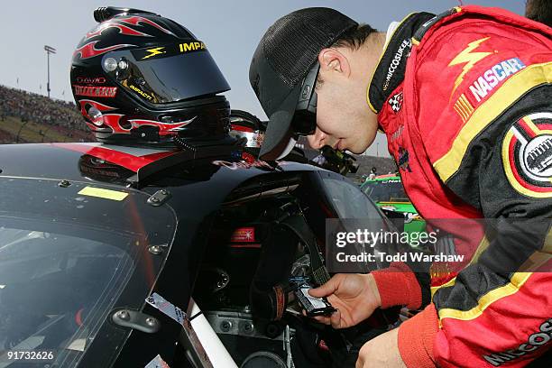 David Gilliland, driver of the Miccosukee Chevrolet, prepares to drive before the NASCAR Nationwide Series Copart 300 at Auto Club Speedway on...