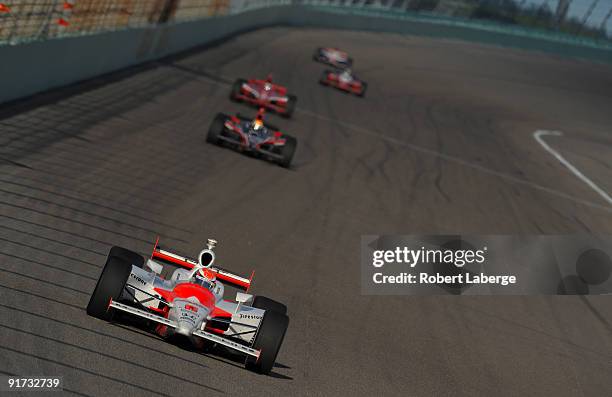 Ryan Briscoe driver of the Team Penske Dallara Honda leads a pack of cars during the IRL IndyCar Series Firestone Indy 300 on October 10, 2009 at...