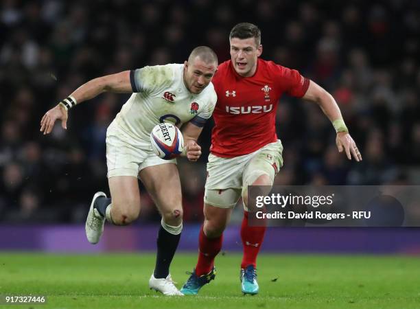 Mike Brown of England chases after the loose ball with Scott Williams during the NatWest Six Nations match between England and Wales at Twickenham...