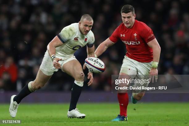 Mike Brown of England chases after the loose ball with Scott Williams during the NatWest Six Nations match between England and Wales at Twickenham...