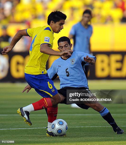 Ecuadorean Cristian Noboa vies for the ball with Uruguayan Walter Gargano during their FIFA World Cup South Africa-2010 qualifier football match at...