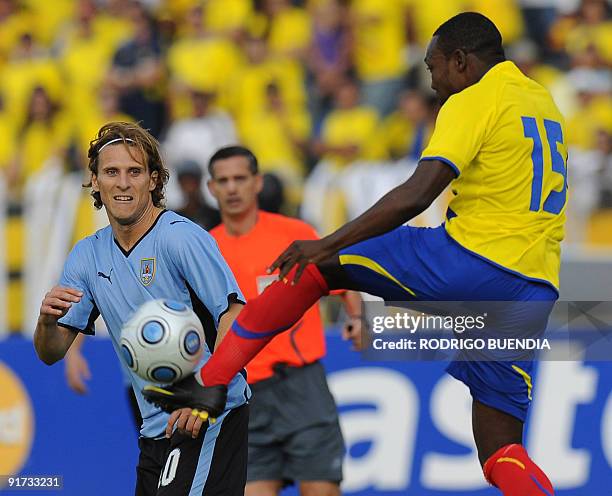 Uruguayan Diego Forlan eyes the ball while Ecuadorean Walter Ayovi shoots during their FIFA World Cup South Africa-2010 qualifier football match at...