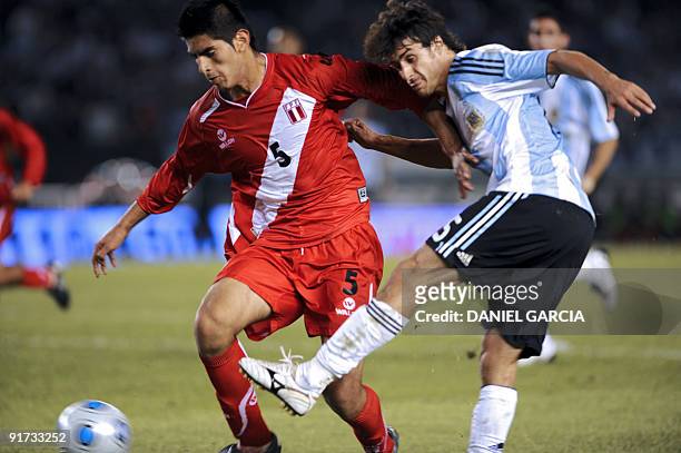 Argentina's midfielder Pablo Aimar vies for the ball with Peru's defender Carlos Zambrano during their FIFA World Cup South Africa-2010 qualifier...