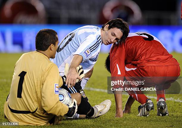 Argentina's forward Lionel Messi helps Peru's goalkeeper Leao Butron next to Peruvian Carlos Zambrano during their FIFA World Cup South Africa-2010...