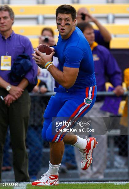Quarterback Tim Tebow of the Florida Gators warms up on the field before the game against the Louisiana State University Tigers at Tiger Stadium on...