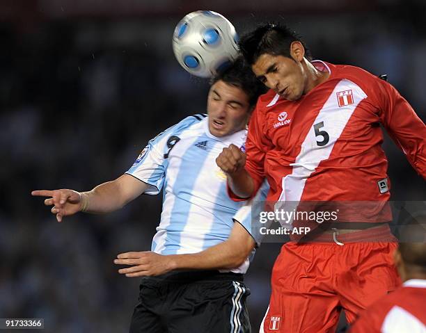 Argentina's forward Gonzalo Higuain vies for the ball with Peru's midfielder Carlos Zambrano during their FIFA World Cup South Africa-2010 qualifier...