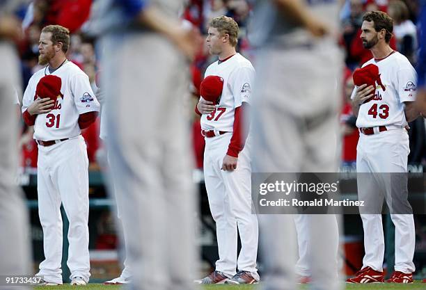 Ryan Franklin, Todd Wellemeyer and Trevor Miller of the St. Louis Cardinals stand for the National Anthem before their team takes on the Los Angeles...