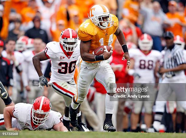 Eric Berry of the Tennessee Volunteers runs with the ball after intercepting a pass during the SEC game against the Georgia Bulldogs at Neyland...