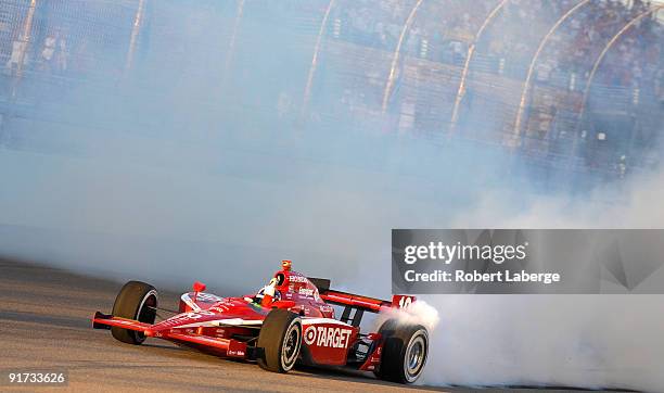 Dario Franchitti driver of the Target Chip Ganassi Racing Dallara Honda celebrates after winning the IRL IndyCar Series Firestone Indy 300 and the...