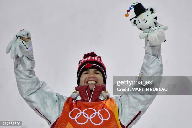 Canada's Mikael Kingsbury celebrates on the podium during the victory ceremony after the men's moguls final during the Pyeongchang 2018 Winter...