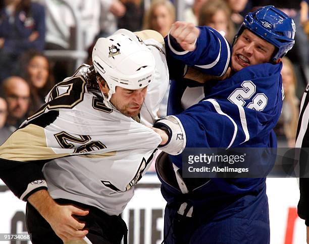 Colton Orr of the Toronto Maple Leafs punches Eric Godard of the Pittsburgh Penguins during a NHL game at the Air Canada Centre on October 10, 2009...