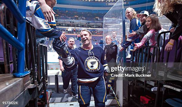 Cam Janssen of the St. Louis Blues high fives a fan before the game against the Los Angeles Kings on October 10, 2009 at Scottrade Center in St....