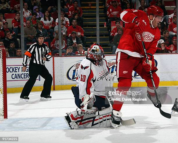 Dan Cleary of the Detroit Red Wings is ready to assist the goal made by his teammate Ville Leino as Jose Theodore of the Washington Capitals defends...
