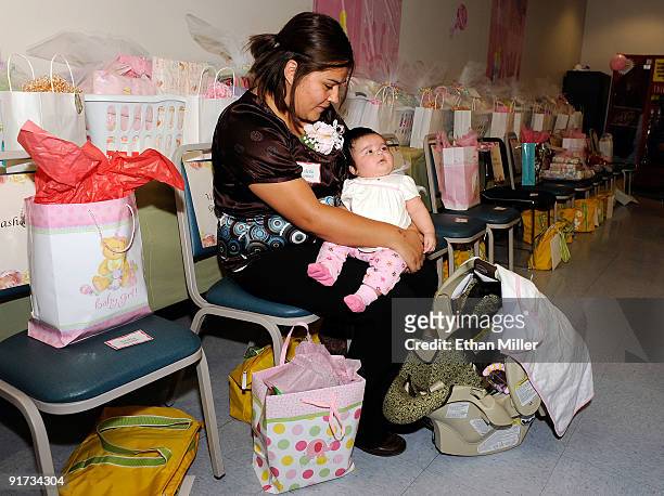 Valerie Gomez holds her two month-old daughter Eliana Gomez during a baby shower held at Nellis Air Force Base for new and expectant mothers who have...