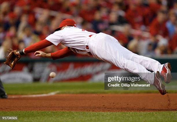 Mark DeRosa of the St. Louis Cardinals fails to make a catch on a line drive against the Los Angeles Dodgers in the fourth inning of Game Three of...