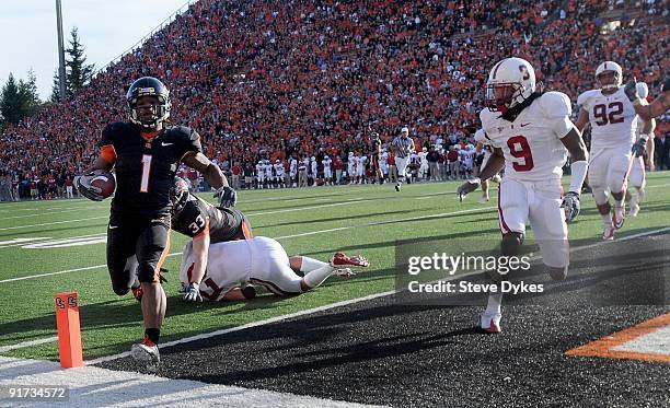 Running back Jacquizz Rodgers of the Oregon State Beavers crosses the goal line for a touchdown as cornerback Richard Sherman of the Stanford...