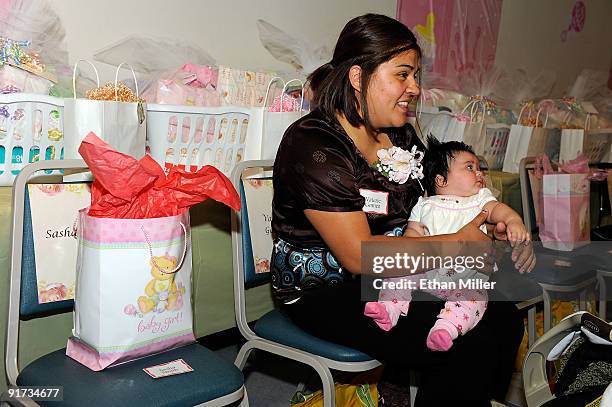 Valerie Gomez holds her two month-old daughter Eliana Gomez during a baby shower held at Nellis Air Force Base for new and expectant mothers who have...