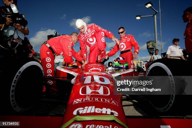 Dario Franchitti climbs aboard the Target Chip Ganassi Racing Dallara Honda before the start of the IRL IndyCar Series Firestone Indy 300 on October...