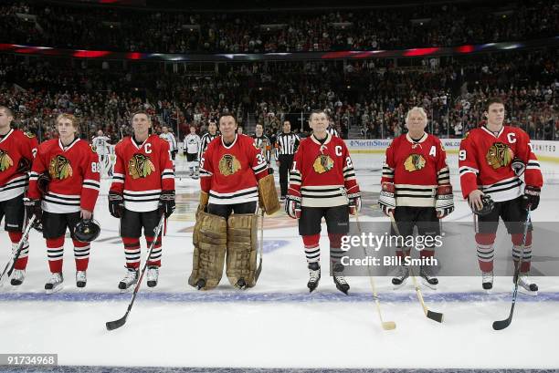 Chicago Blackhawks Legends Denis Savard, Tony Espositio, Stan Mikita, and Bobby Hull stand in between Patrick Kane and Jonathan Toews during the...