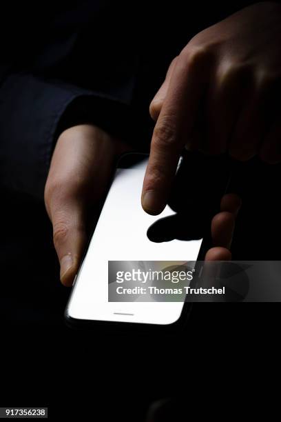 Berlin, Germany Symbolic photo on the subject of data security on the smartphone. Hands are typing on a smartphone on February 12, 2018 in Berlin,...