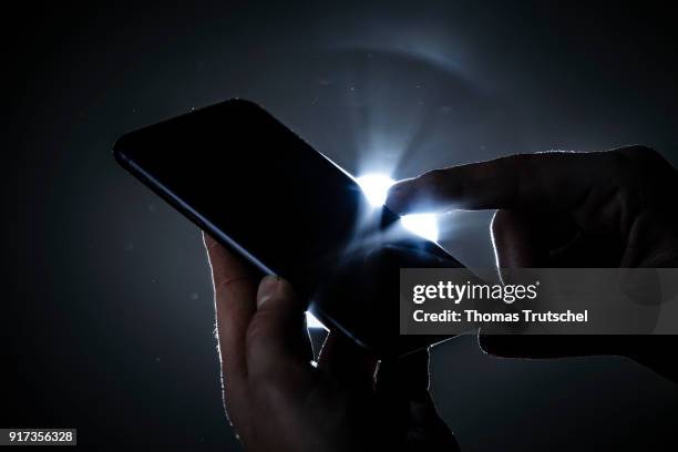 Berlin, Germany Symbolic photo on the subject of data security on the smartphone. Hands are typing on a smartphone on February 12, 2018 in Berlin,...