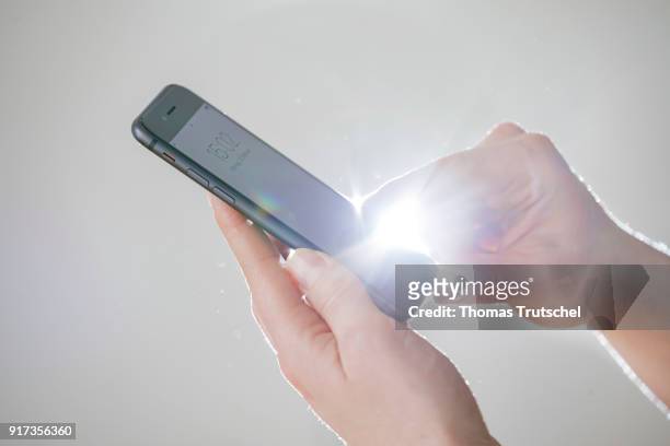 Berlin, Germany Symbolic photo on the subject of data security on the smartphone. Hands are typing on a smartphone on February 12, 2018 in Berlin,...