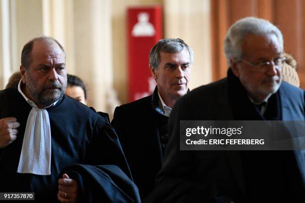 French former budget minister Jerome Cahuzac , flanked by his lawyers Jean-Alain Michel and Eric Dupond-Moretti walks at the Paris courthouse during...